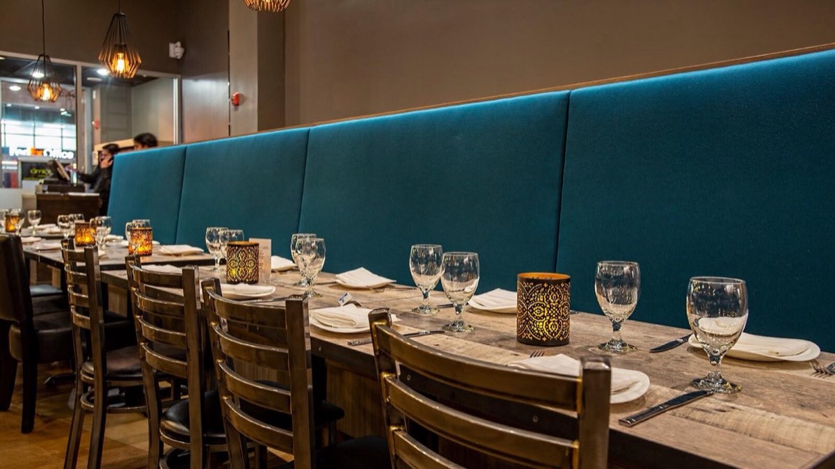 Amiya: booth seating set for dinner. Photo from their website.