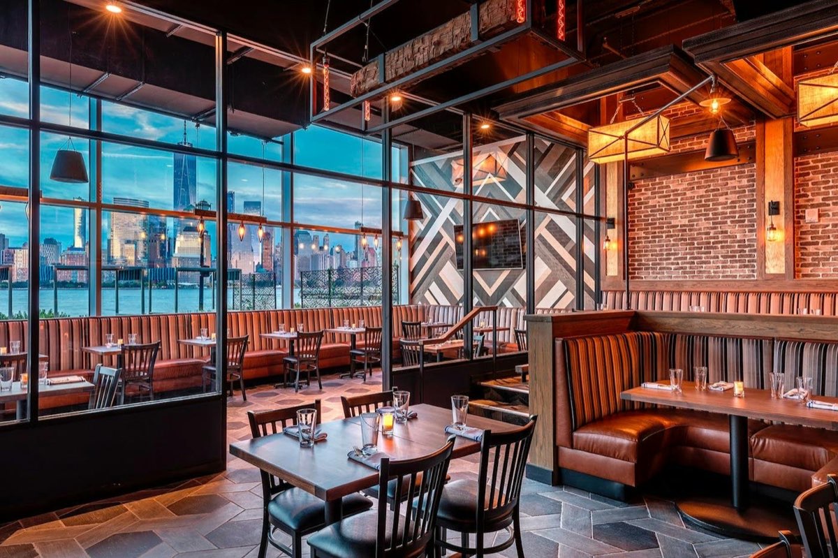 Hudson & Co.: dining room booths with a Jersey City skyline view. Photo from their website.