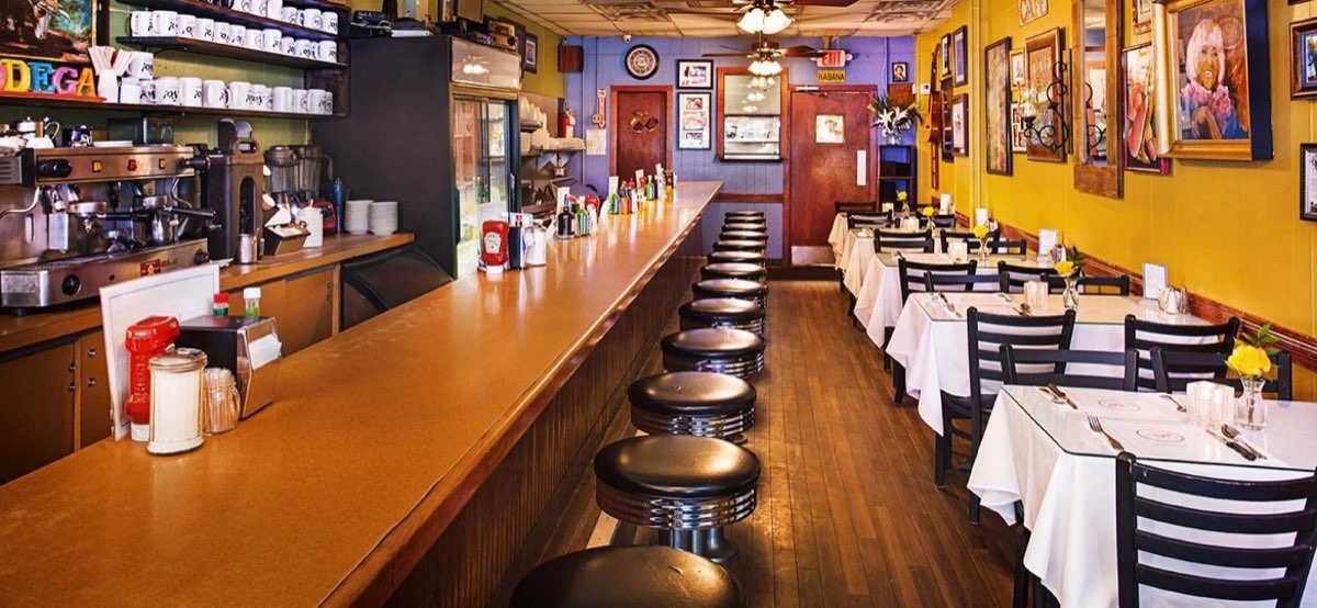 La Isla: diner counter and dining room with yellow walls. Photo from their website.
