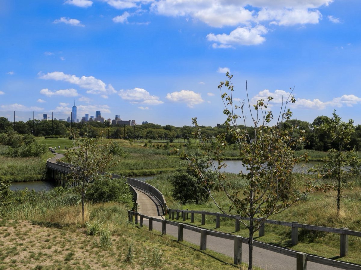 Boardwalk through the marsh at Lincoln Park, Jersey City, with the skyline behind