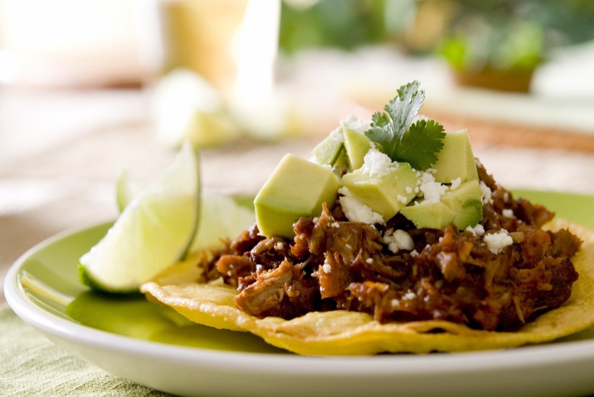 Mi Mariachi Taqueria: tostada topped with shredded meat, avocado and lime. Photo from their website.