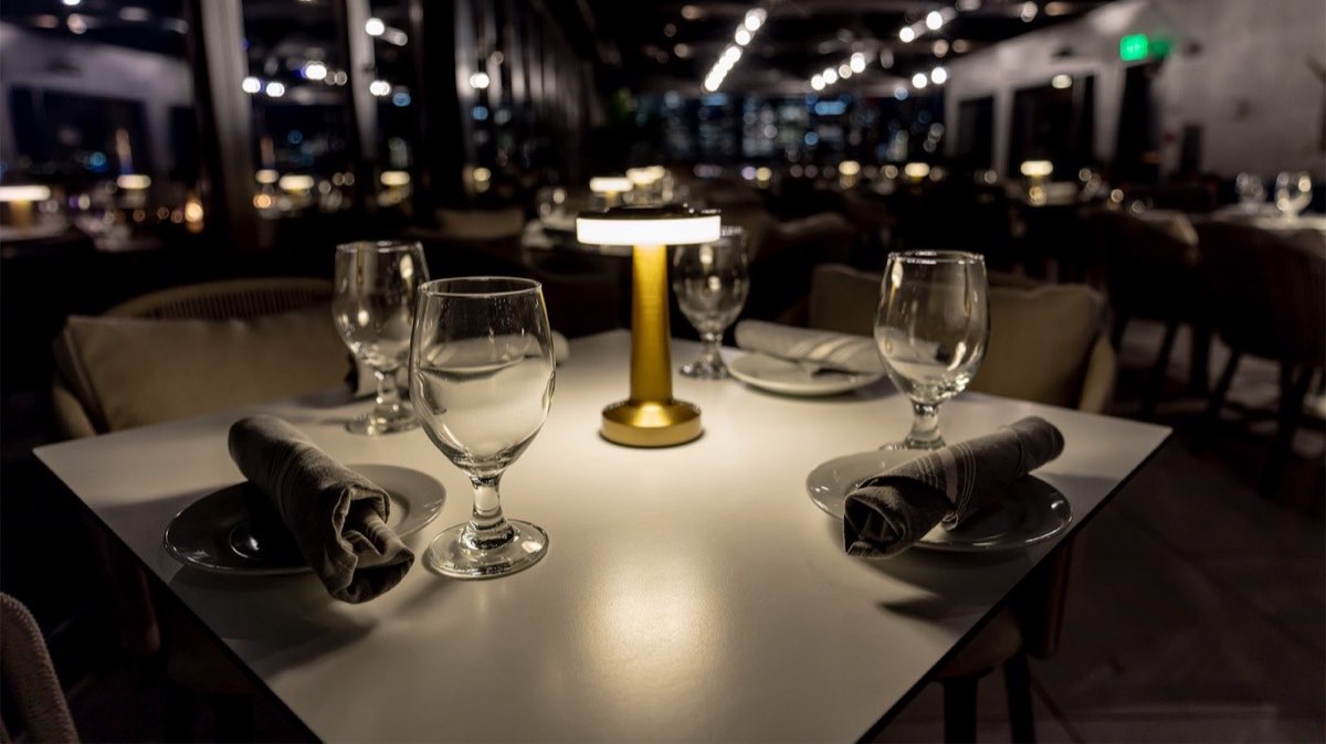 RoofTop at the Exchange: a candlelit rooftop table at night. Photo from their website.