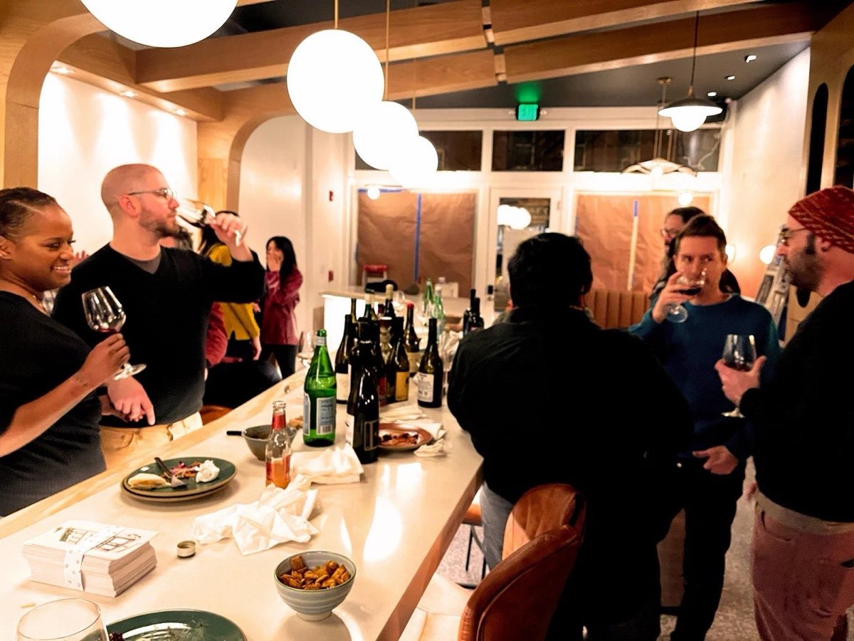 The Alps: guests at the bar under globe pendant lights. Photo from their website.