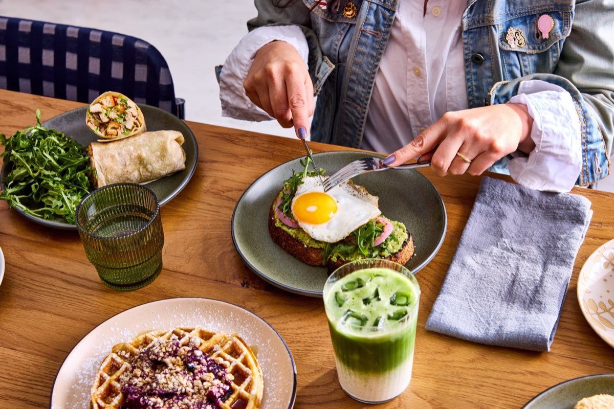 The Cafe at Journal Squared: brunch spread of toast, waffle, wrap and iced matcha. Photo from their website.