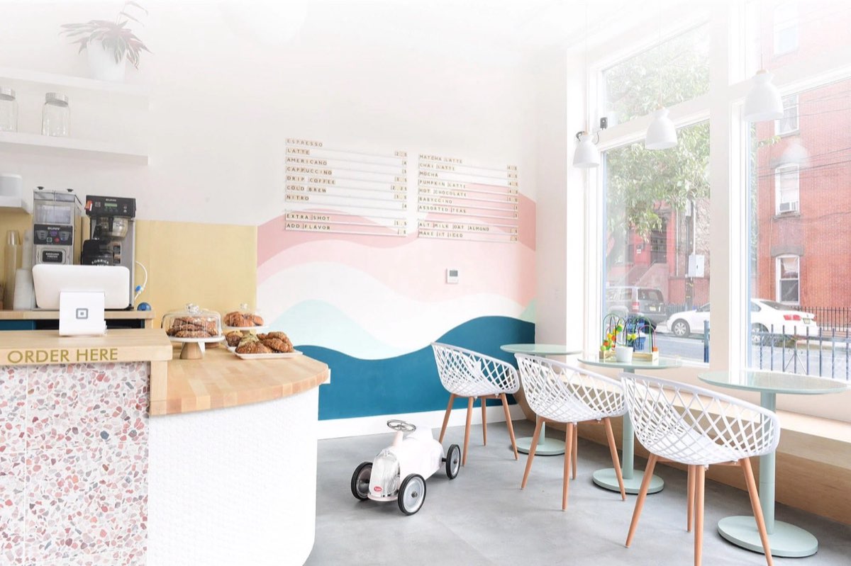 The Hive: bright cafe interior with pastry case and seating. Photo from their website.