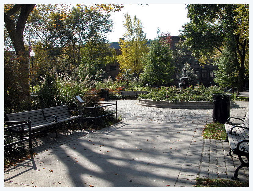 Van Vorst Park: park benches, fountain and brownstones under autumn trees. Photo from their website.